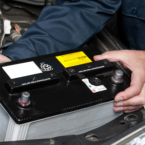 Hands holding a car battery replacement in Safety Harbor, FL