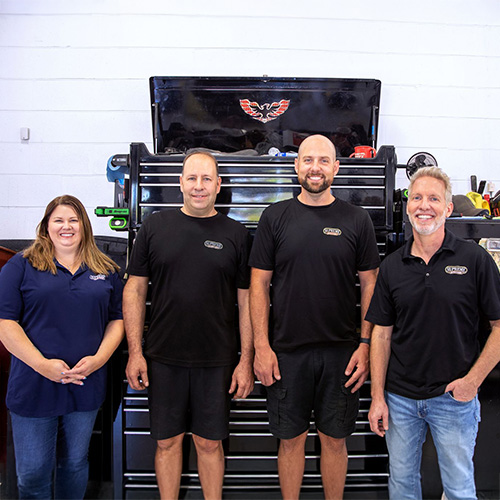 2 men and two women posed inside Supreme Auto Repair in Safety Harbor