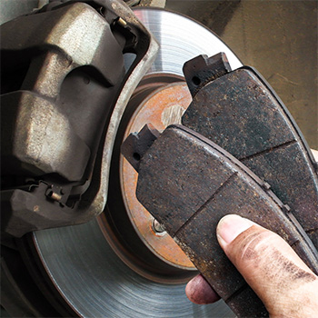 Hands holding brake repair tool