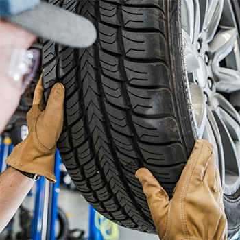 Tire treads getting checked by a mechanic