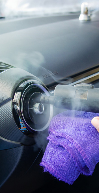 Air vents being cleaned inside a car